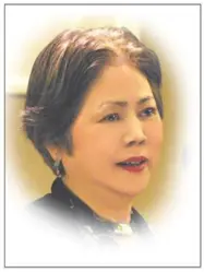 Photo of Aki Sogabe starring off  into the distance