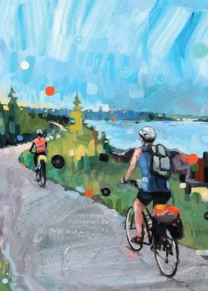 two bicycle riders on paved path next to blue lake and sky
