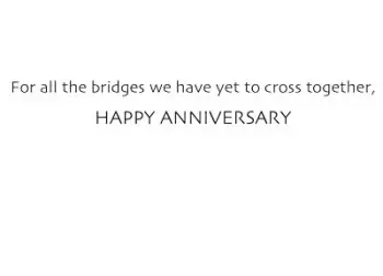 a painted red and blue bike parked on a bridge on a canal in Amsterdam