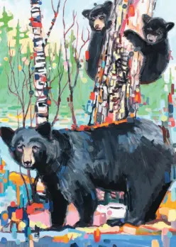 black bear in front of colorful birch trees with two baby black bears climbing one tree