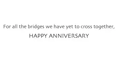 a painted red and blue bike parked on a bridge on a canal in Amsterdam