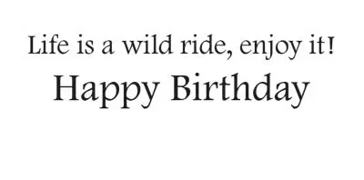 red bike on green grass in front of blue lake and pine trees